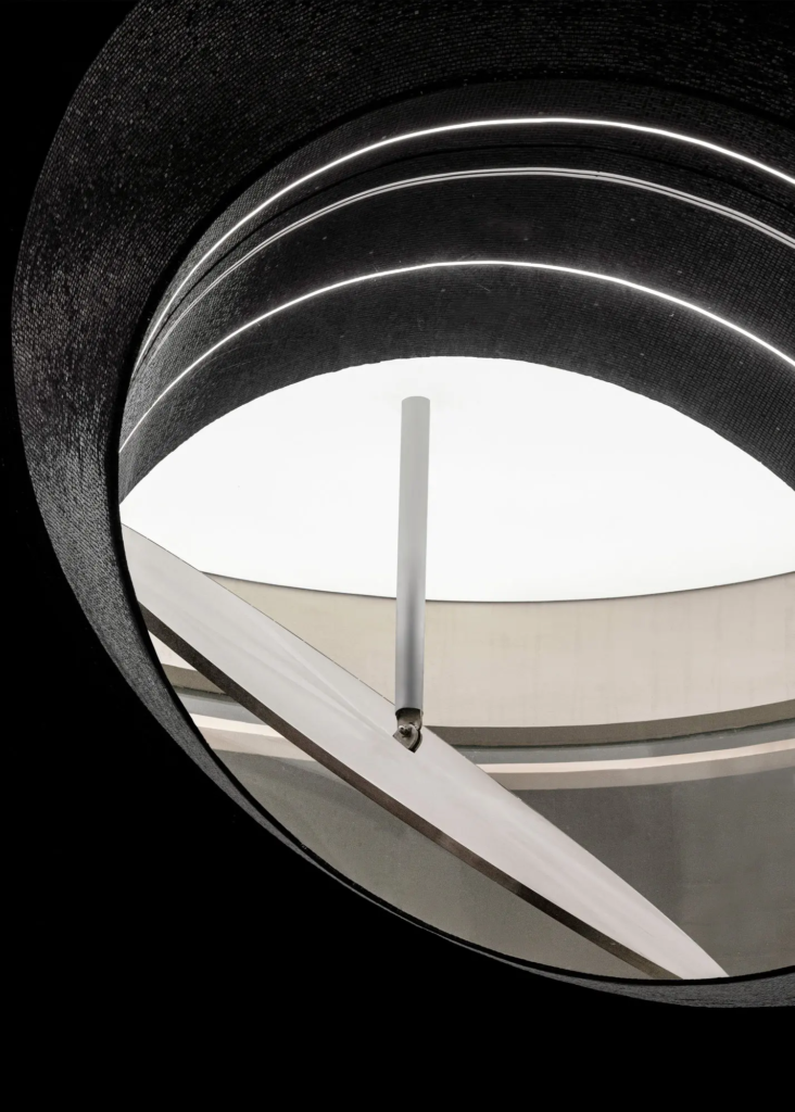 Large-scale black mosaic application surrounding the spiral staircase