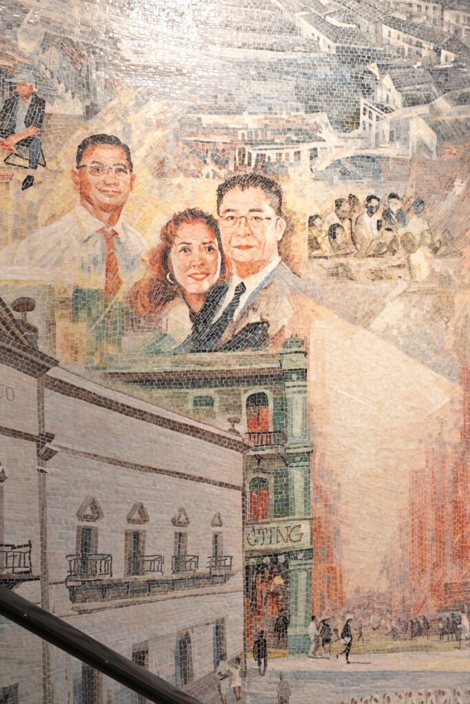 Close-up of the mosaic mural at New Hotel Central, showing micro hand-cut tiles precisely crafting the lifelike facial features and expressions of historical figures