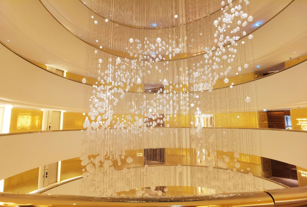 Luxury hotel corridor wall decorated with JNJ 24K gold foil mosaic tiles at Fairmont Doha