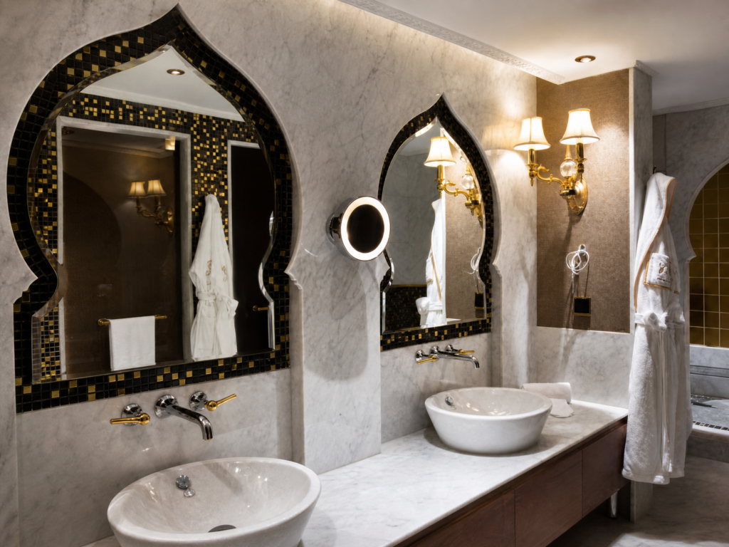 Elegant bathroom vanity mirror frame accented with custom dark brown and gold foil mosaic tiles