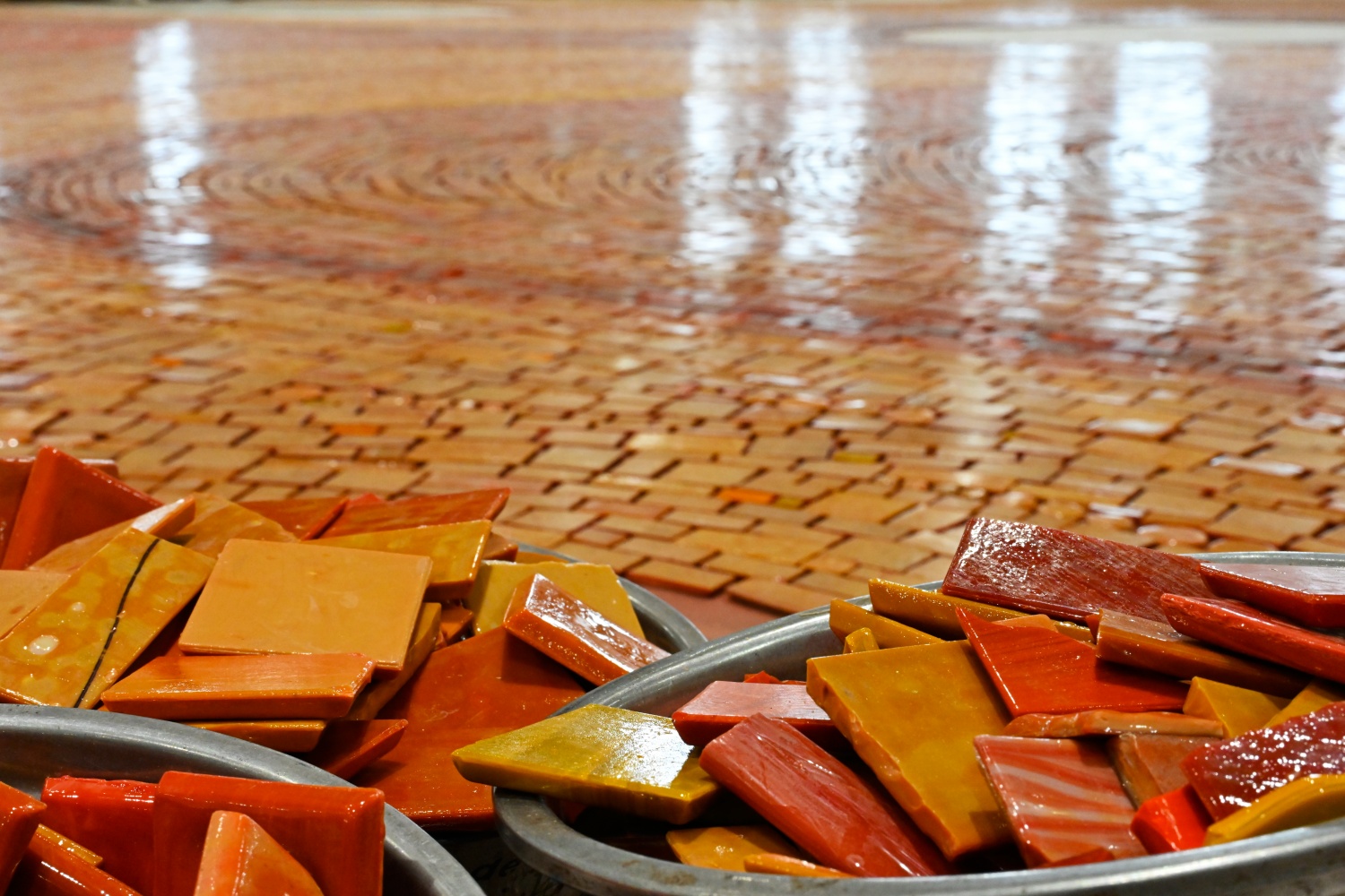 Custom red, orange and yellow glass mosaic pieces prepared for handcrafted assembly