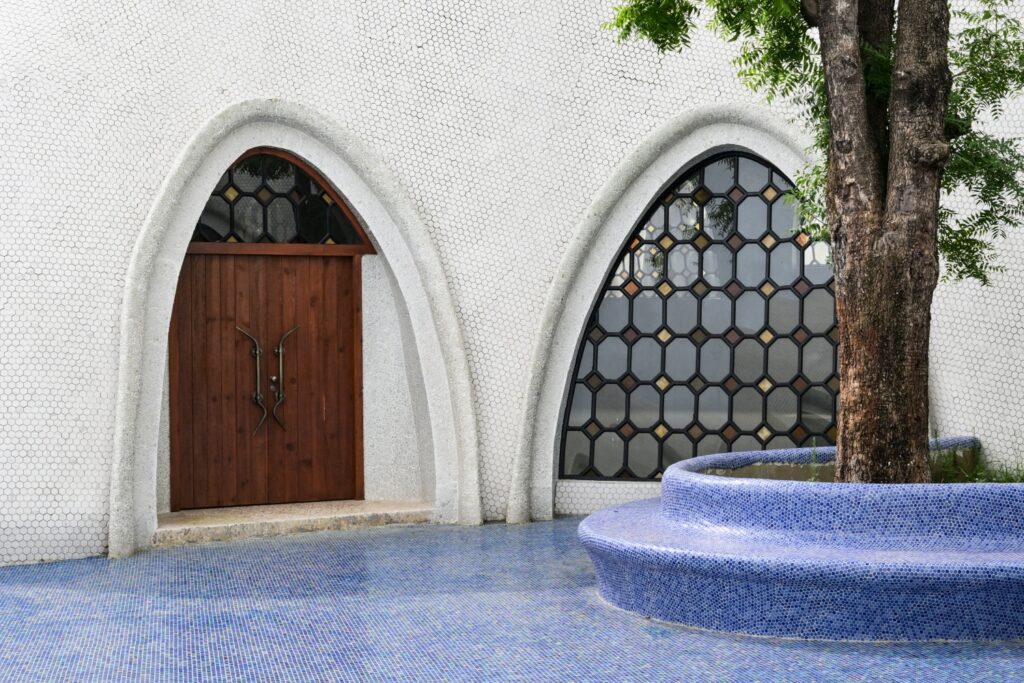 Curved blue mosaic seating beside arched windows at The Cloud Art Palace