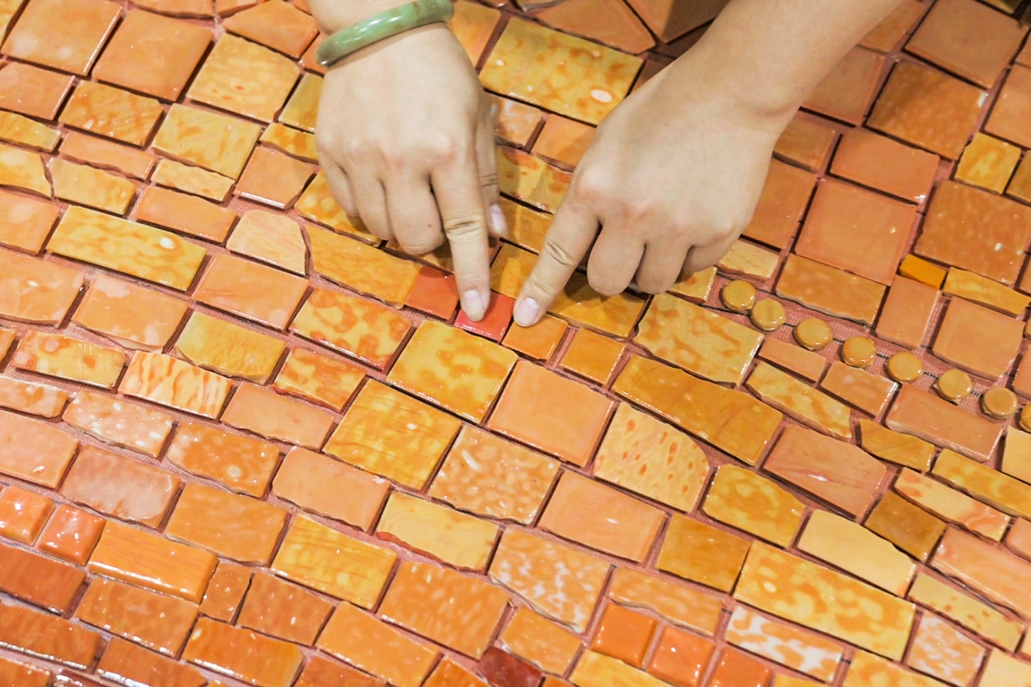 Artisan hand-placing custom glass mosaic pieces for The Cloud Art Palace