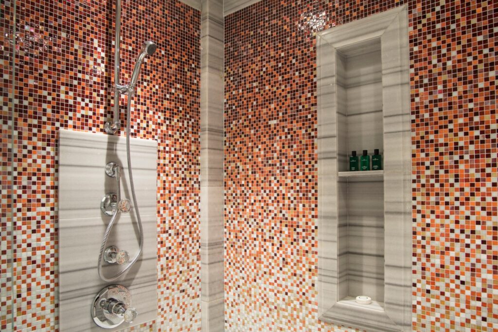 The Reverie Saigon luxury hotel bathroom featuring custom JNJMosaic artistic wall tiles