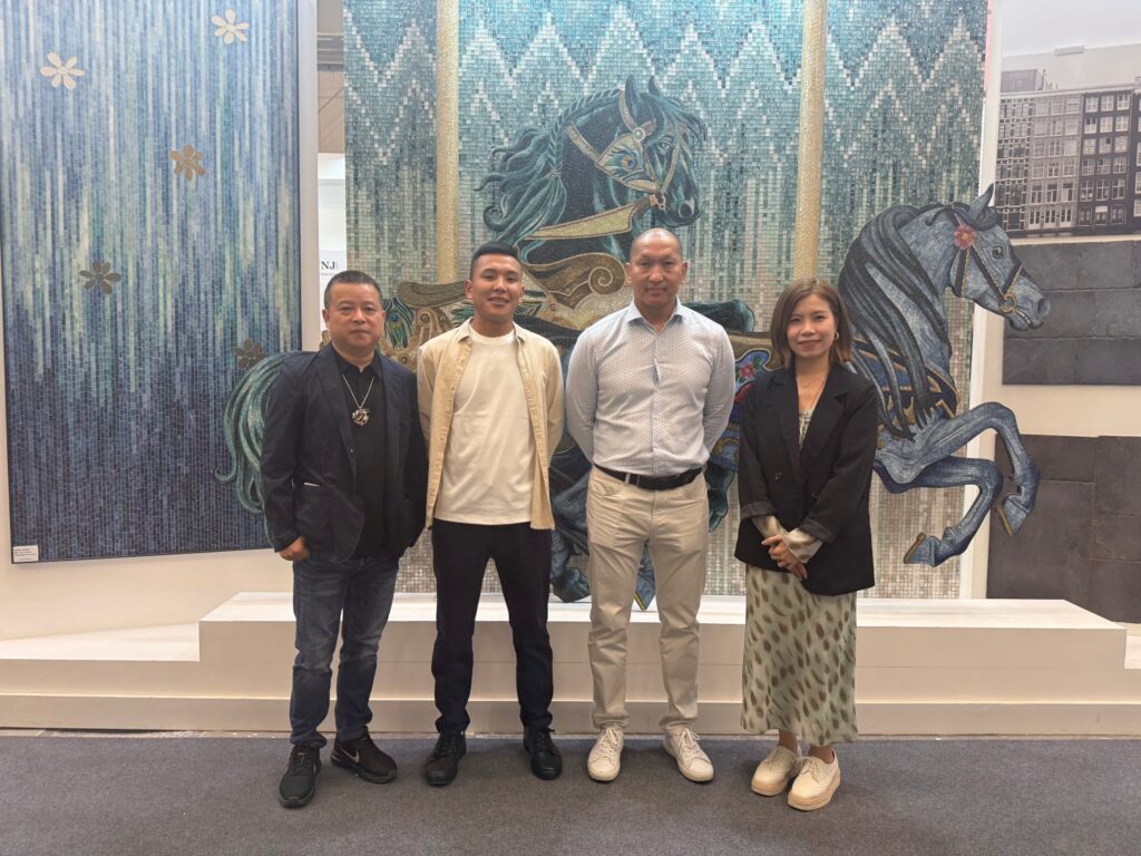 From Chinese Creation to Global Expression: JNJMosaic at CERSAIE 2026 12 JNJMosaic team and partners in front of an artistic carousel horse mosaic installation at CERSAIE 2025