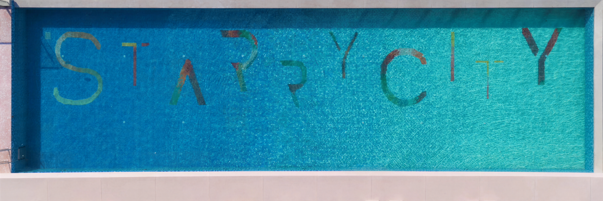 Custom mosaic pool wall design for a luxury outdoor infinity pool