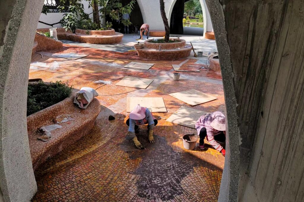 Artisans installing custom glass mosaic flooring on site at The Cloud Art Palace
