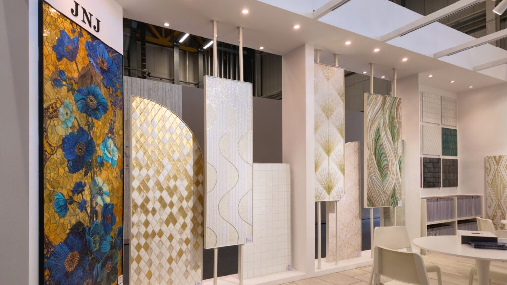 Artistic mosaic mural and decorative panels displayed at the JNJ booth