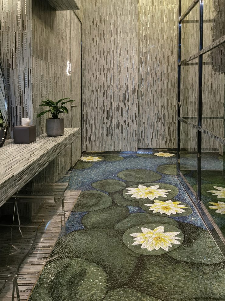 Elegant luxury restroom interior featuring stunning blue mosaic flooring and artistic lotus wall patterns