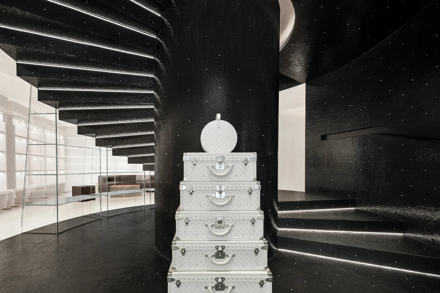 Feature spiral staircase wrapped in custom black mosaic installation