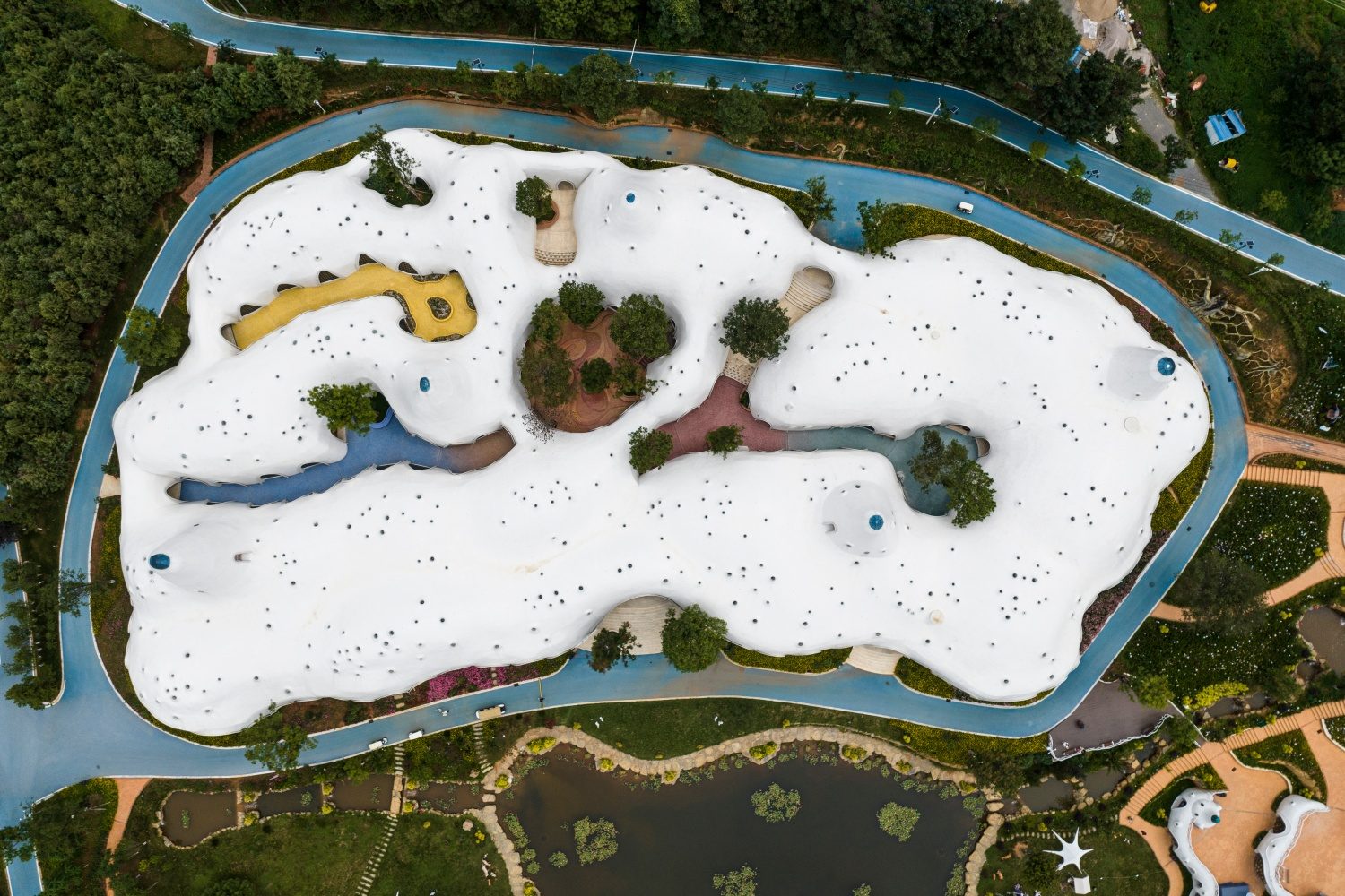 Top-down aerial view of The Cloud Art Palace and its colorful mosaic corridors in Yunnan
