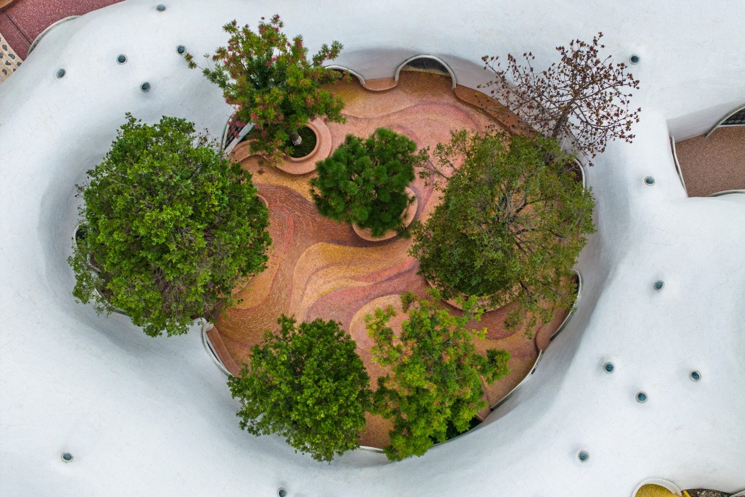 Aerial view of the red earth-inspired mosaic courtyard at The Cloud Art Palac