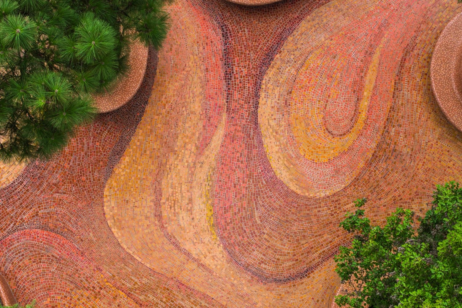 Flowing red and orange glass mosaic patterns inspired by Yunnan’s red earth