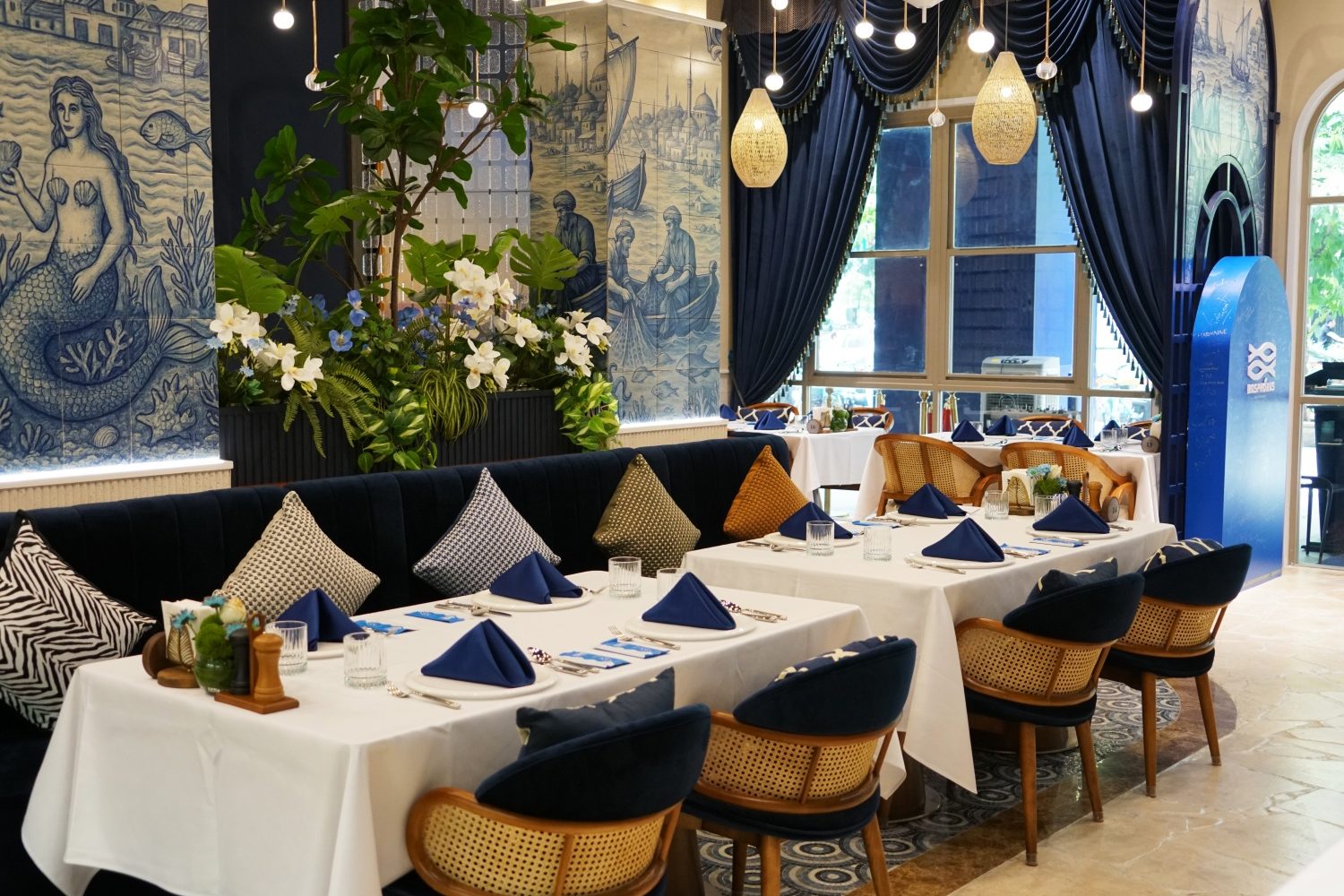 Multi-surface mosaic application across wall seating and flooring
