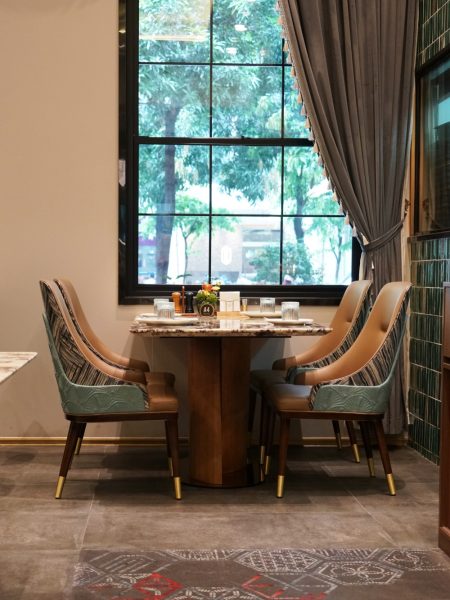 The flooring features glass mosaic inlay tiles
