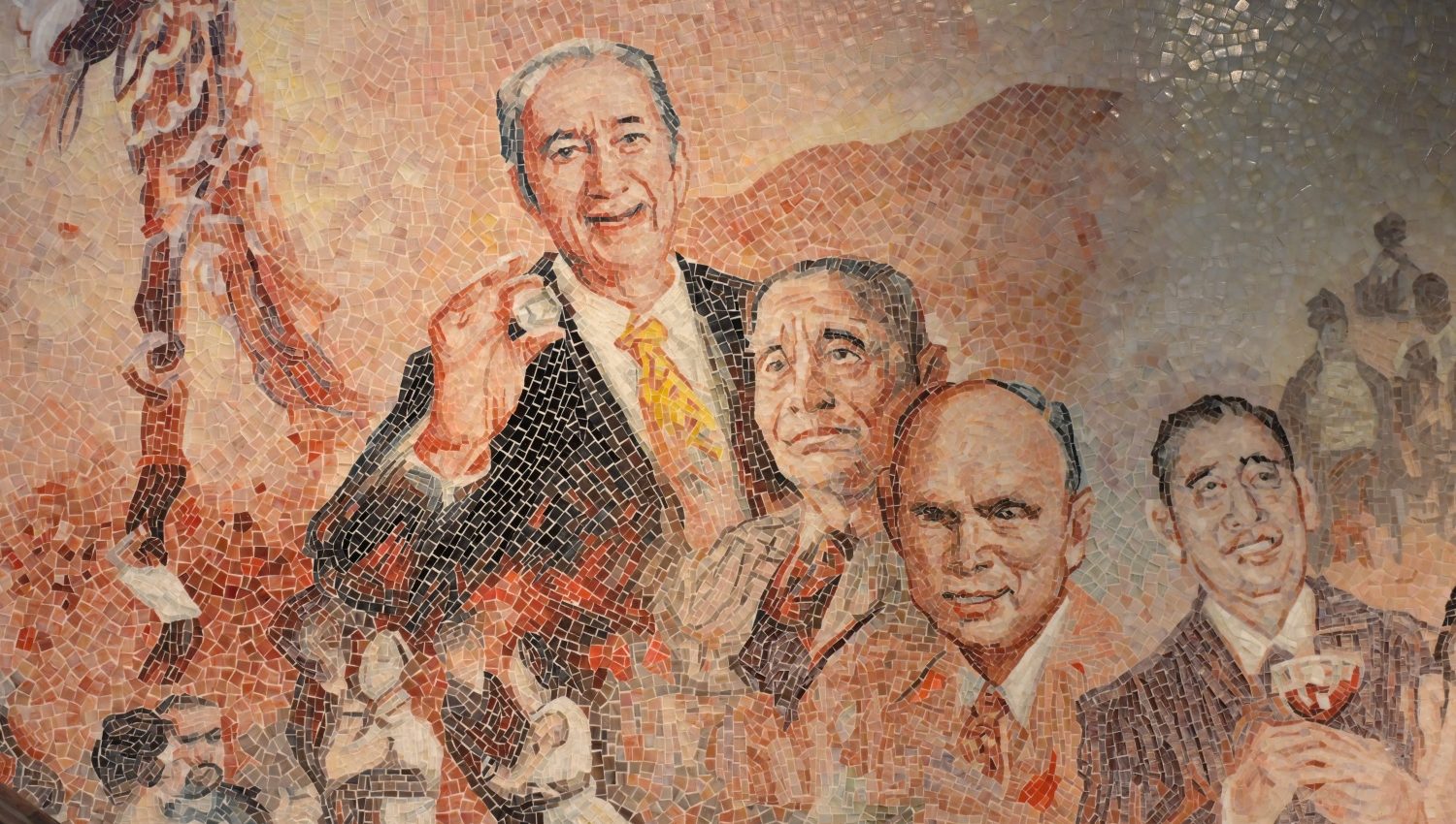 Close-up detail of New Hotel Central mosaic mural: micro hand-cut tiles depicting realistic facial features and expressions of historical figures.