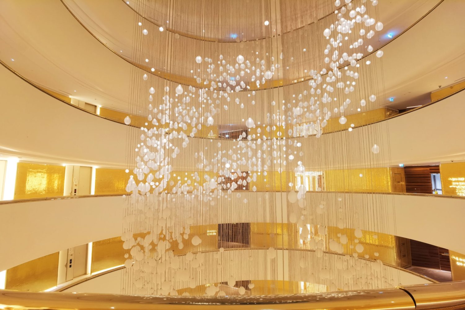 Luxury hotel corridor wall decorated with JNJ 24K gold foil mosaic tiles at Fairmont Doha