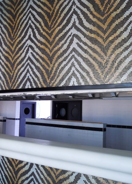 Zebra-pattern mosaic wall created with sieve plate technique in the restaurant interior