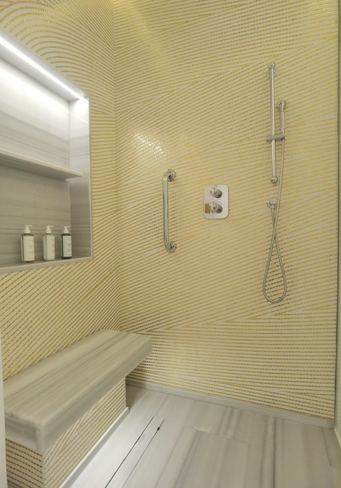 Modern shower wall decorated with fluid mosaic tile patterns inspired by sand dunes and desert motifs