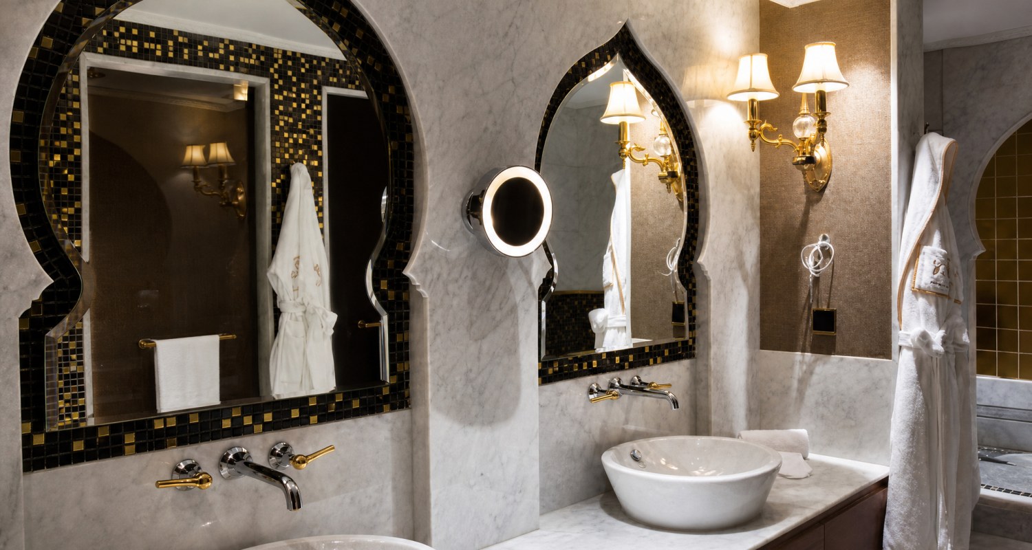 Elegant bathroom vanity mirror frame accented with custom dark brown and gold foil mosaic tiles